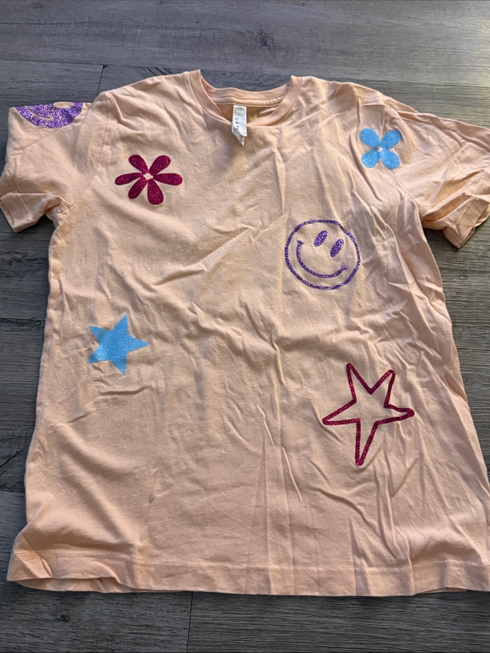 Girls Peach Glitter Graphic Tee with Colorful Stars & Smile